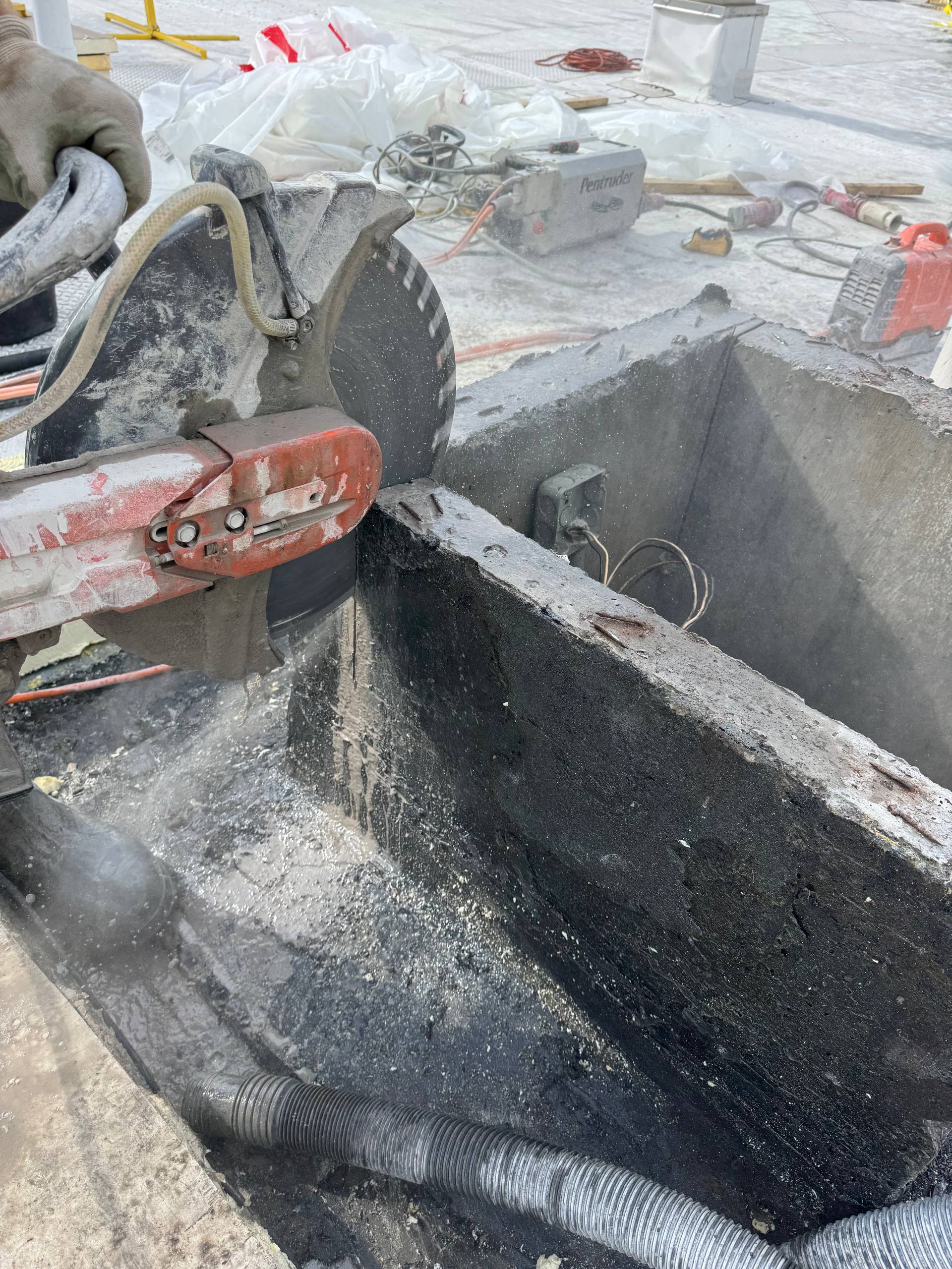 Diamond ring saw cutting through reinforced concrete wall at close range on job site