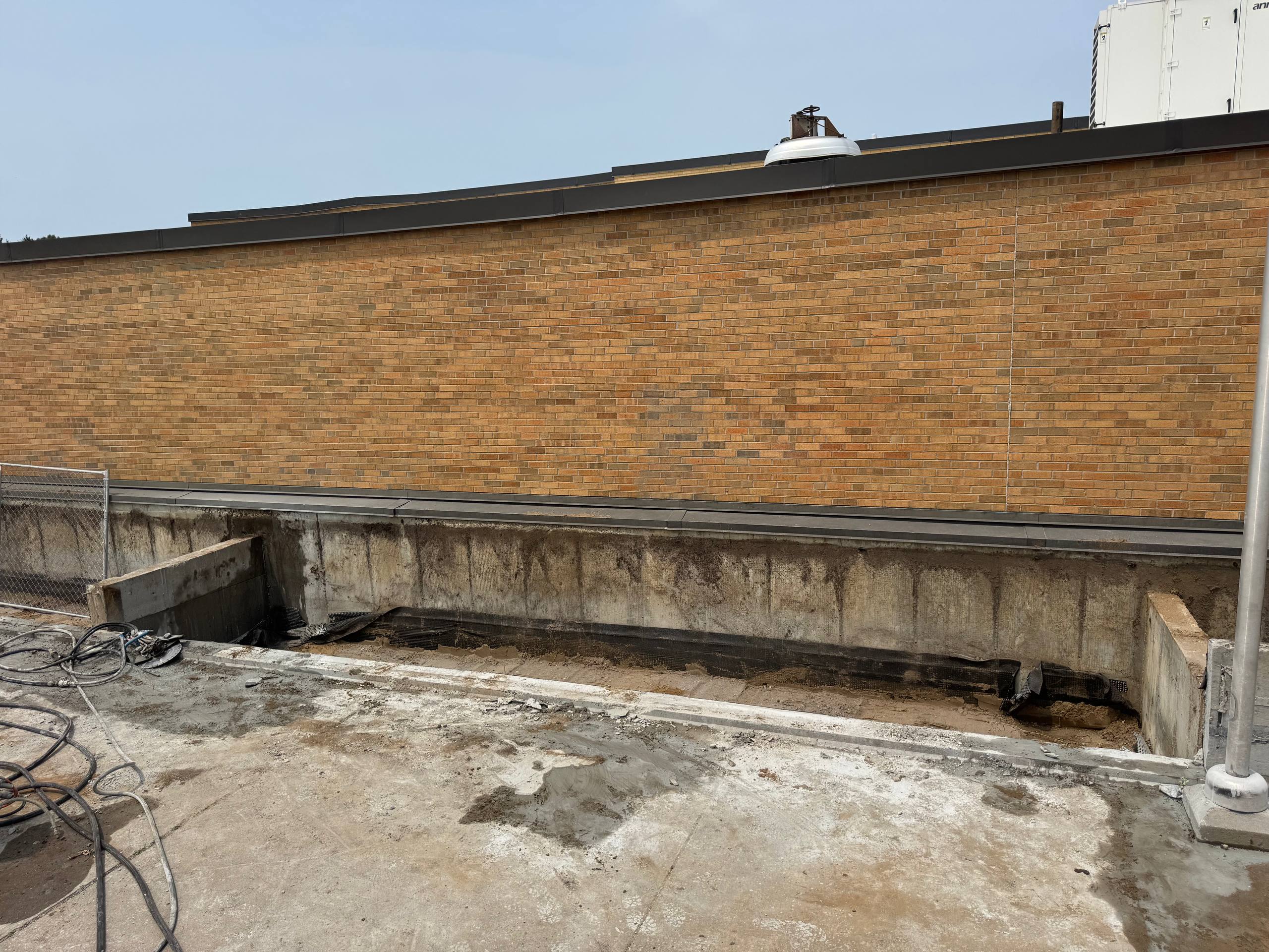 Commercial building wall saw cutting along brick facade for renovation